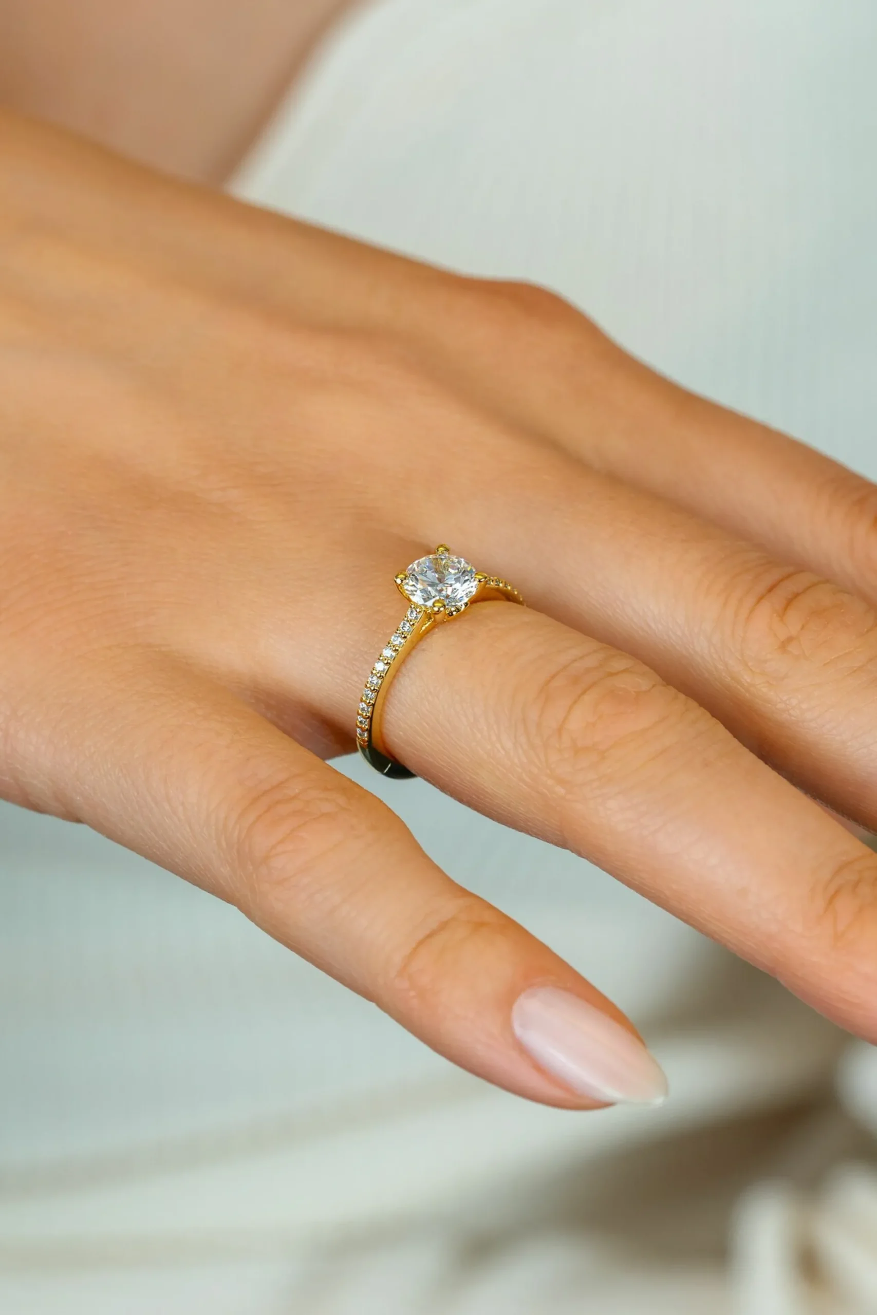 ZINZI gold plated zilveren verlovingsring met een grote ronde witte zirkonia (6,5mm) in vierpootszetting en klein hartje aan de zijkant ZIR2696Y