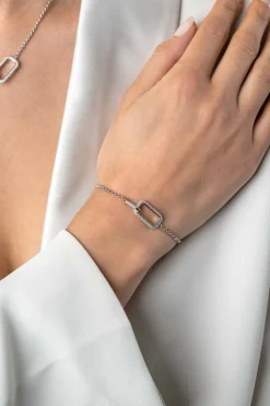 ZINZI zilveren armband met twee verbonden schakels: een rechthoekige bezet met witte zirconia's en een gladde ovale schakel 16,5-19,5cm ZIA2551